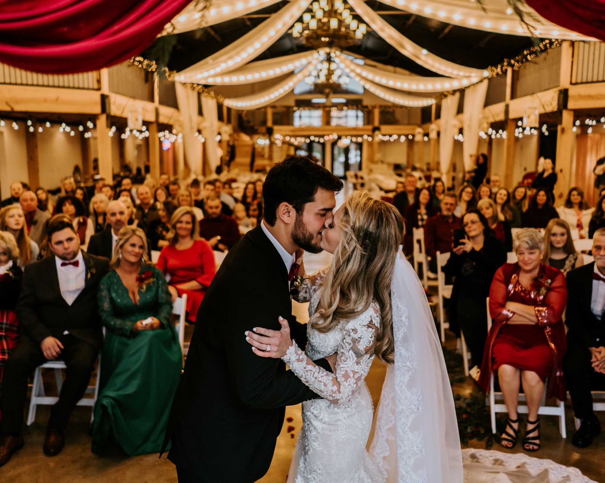 A first kiss as a married couple at The Vineyard Hall - A Rustic Wedding Venue